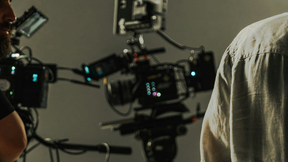 Professional cinema cameras and crew preparing a shot on a studio production set