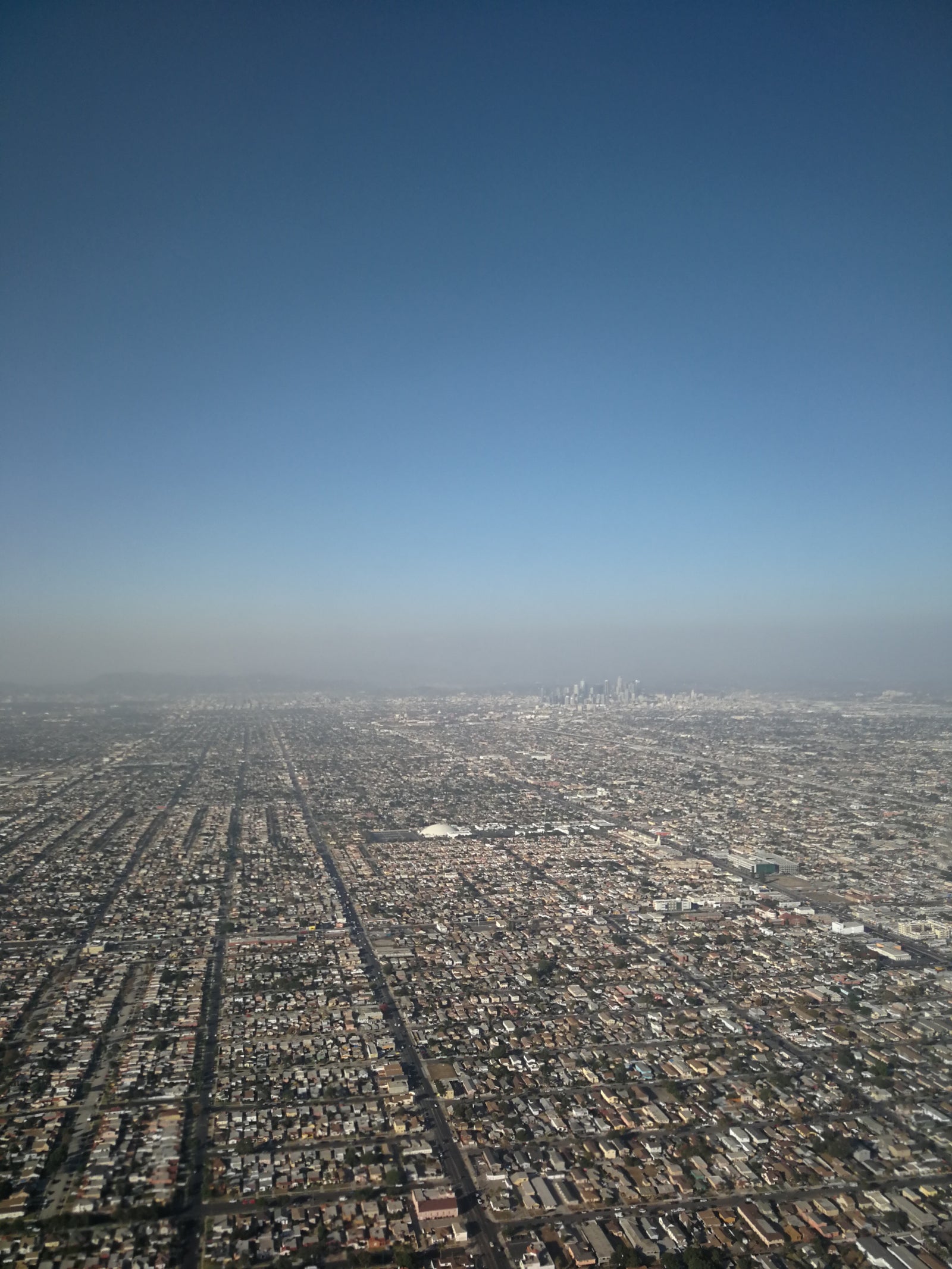 Aerial view across Los Angeles toward its downtown skyline