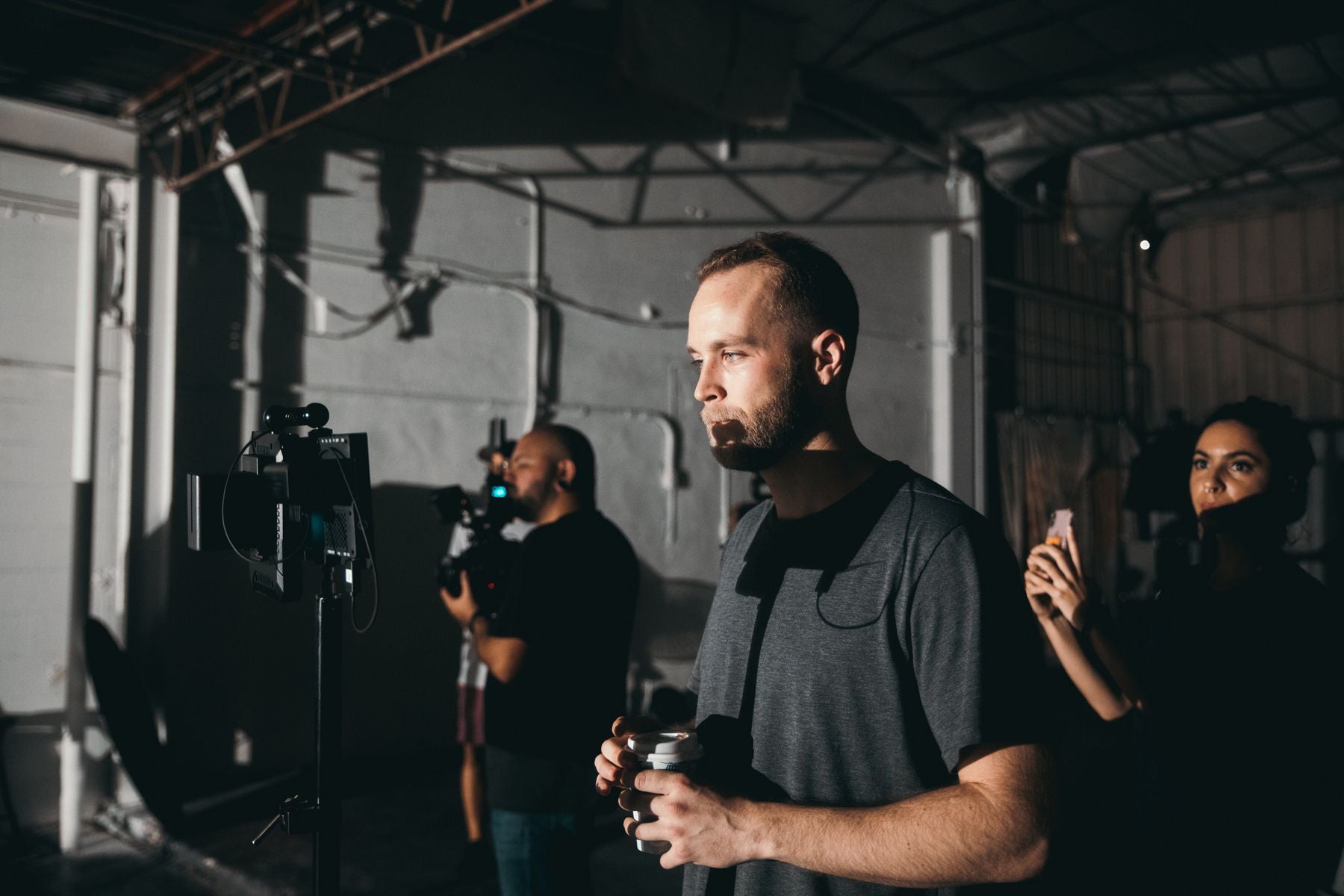 Film crew reviewing a production monitor on set